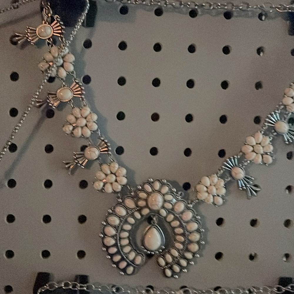 This is a huge cream turquoise piece that has silver chain throughout